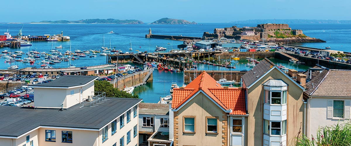 A view over houses to the harbour in St Peter Port, Guernsey